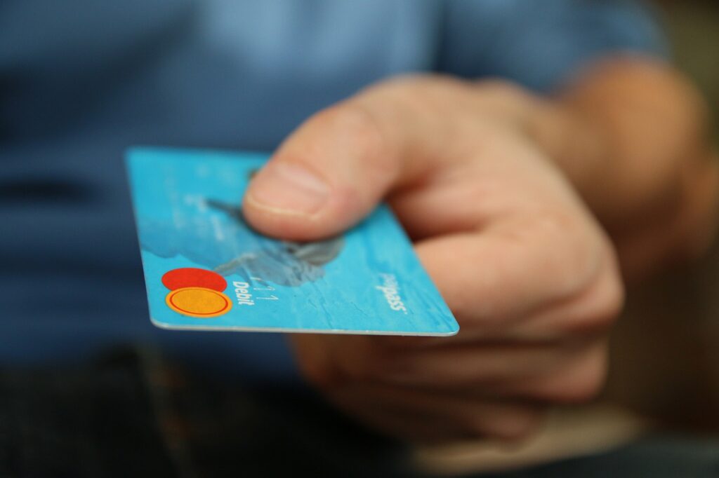 handing a credit card for travel hacking