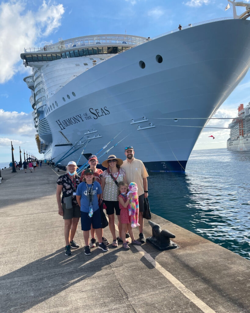 family in front of a cruise ship