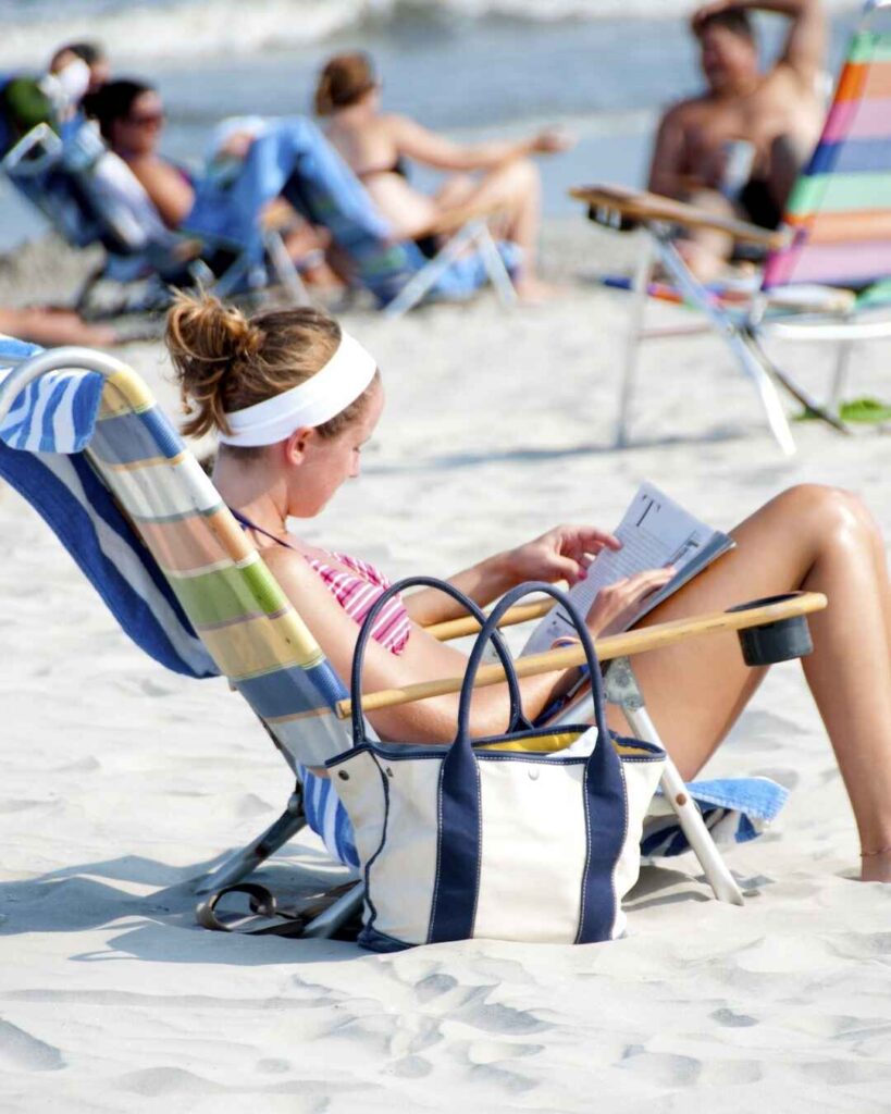 best beaches Nassau, girl reading on beach
